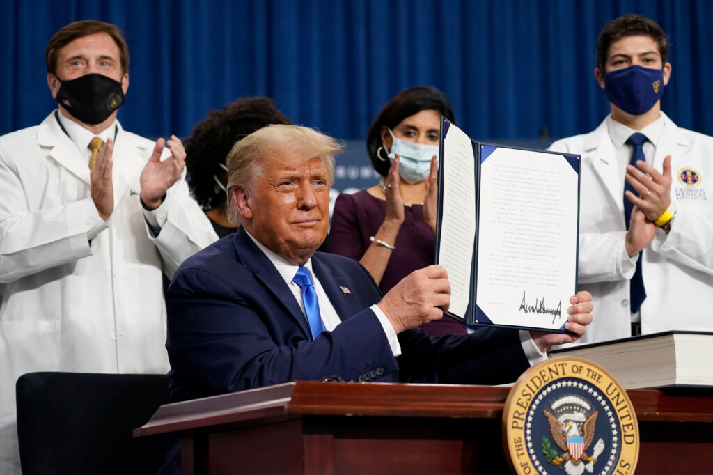 President Trump holds up an executive order after delivering remarks on health care in Charlotte, N.C., on Thursday. President Trump holds up an executive order after delivering remarks on health care in Charlotte, N.C., on Thursday. (Evan Vucci/AP Photo)