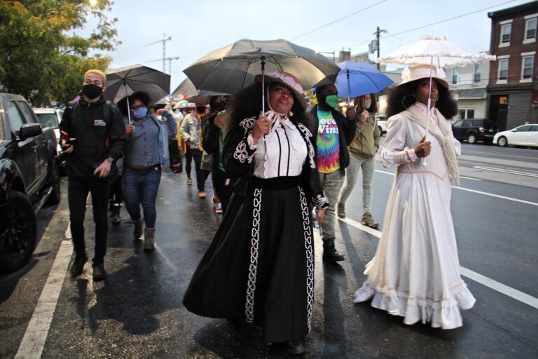 Jeannine Cook (right) owner of Harriett's Bookshop in Fishtown, and her sister Jasmaine Cook, lead a procession on East Girard Avenue