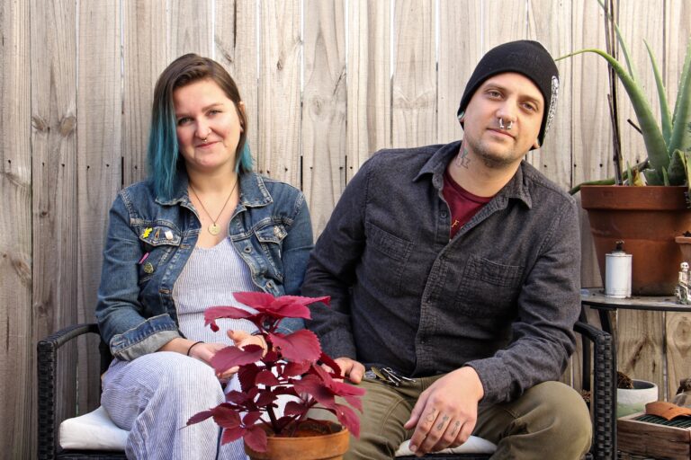 Melissa Durko and Drew Heaton sit in the backyard of their South Philadelphia rowhouse