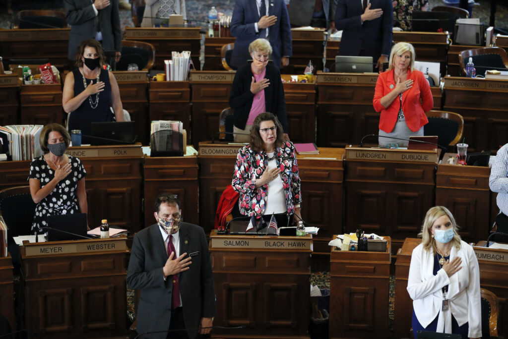 Virus Outbreak Trump State Republicans In this Wednesday, June 3, 2020 file photo, State Representatives stand at their desks during the Pledge of Allegiance in the Iowa House chambers, at the Statehouse in Des Moines, Iowa. (AP Photo/Charlie Neibergall)