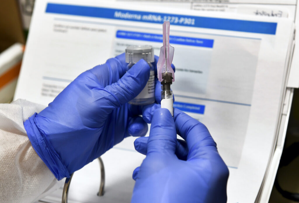 Virus Outbreak Vaccine White House Registered Nurse Kath Olmstead prepares a blinded study experimental vaccine for COVID-19