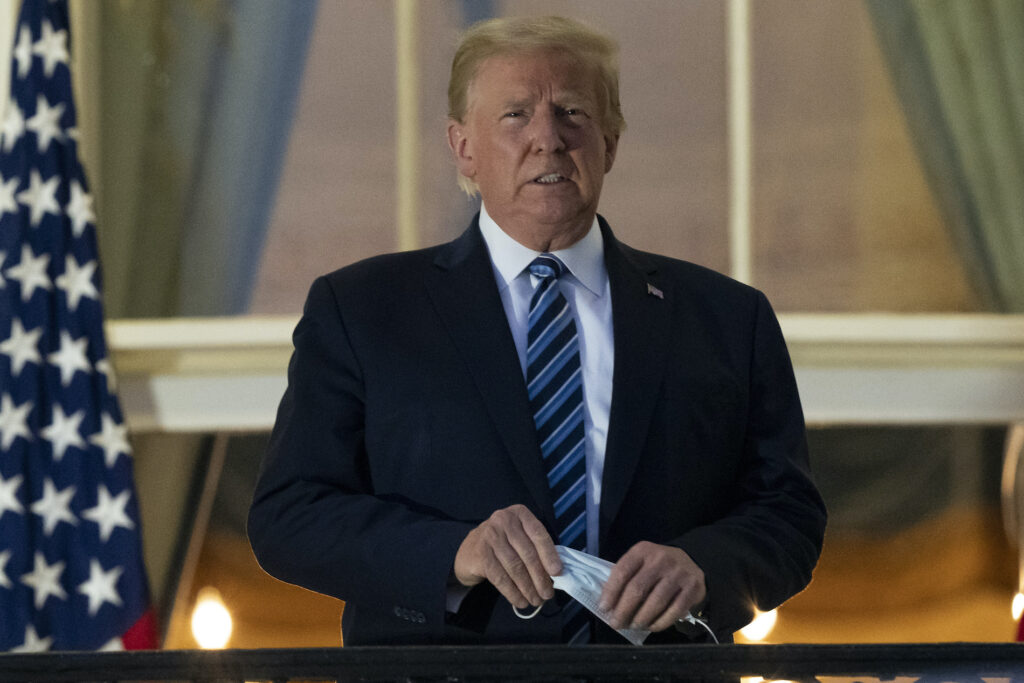 Donald Trump, Donald J. Trump President Donald Trump removes his mask as he stands on the Blue Room Balcony upon returning to the White House Monday, Oct. 5, 2020, in Washington, after leaving Walter Reed National Military Medical Center, in Bethesda, Md. (AP Photo/Alex Brandon)