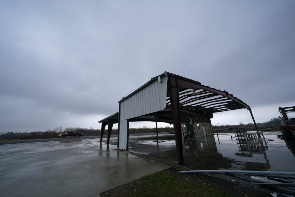 Tropical Weather A car leaves Cameron, La., Thursday, Oct. 8, 2020, past a building destroyed by Hurricane Laura, in advance of Hurricane Delta, expected to make landfall Friday. (AP Photo/Gerald Herbert)