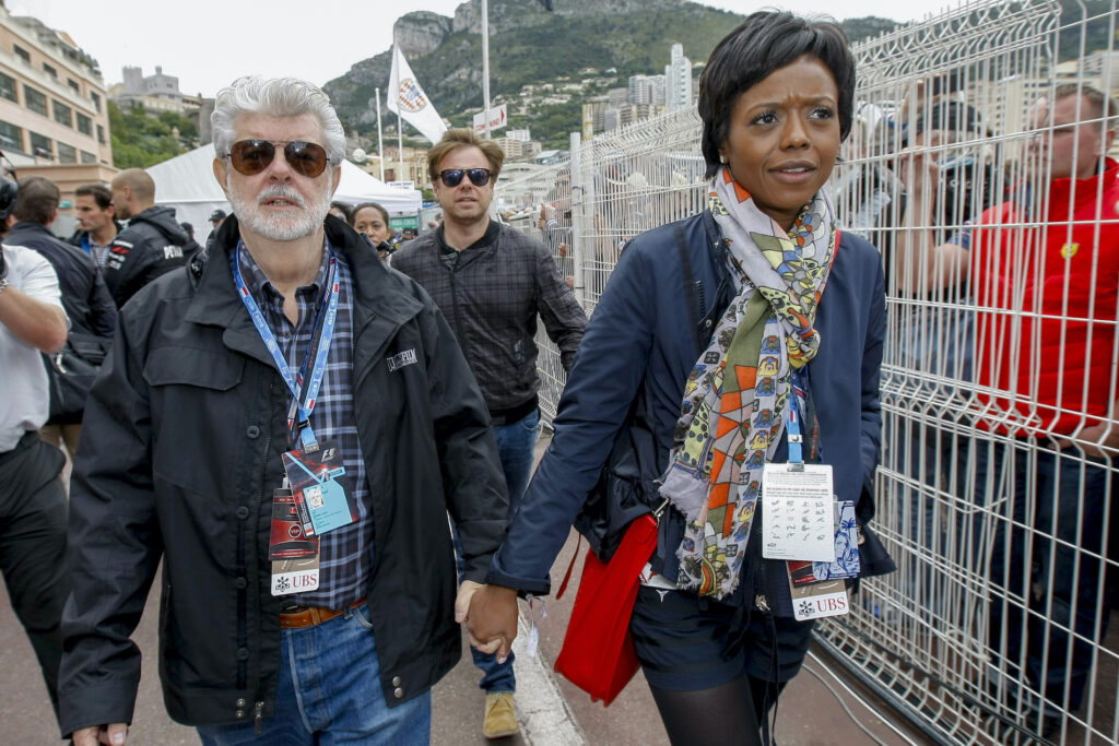 Princeton Dorm Mellody Hobson, right, walks with film director George Lucas after the qualifying session at the Monaco racetrack in Monaco, Saturday, May 25, 2013. (AP Photo/Claude Paris)