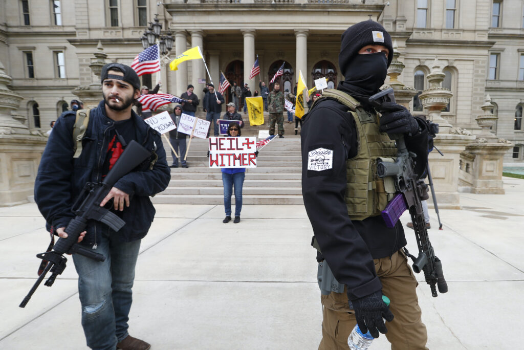 Michigan Governor Kidnapping Plot Protests In this April 15, 2020 file photo, protesters carry rifles near the steps of the Michigan State Capitol building in Lansing, Mich. (AP Photo/Paul Sancya)