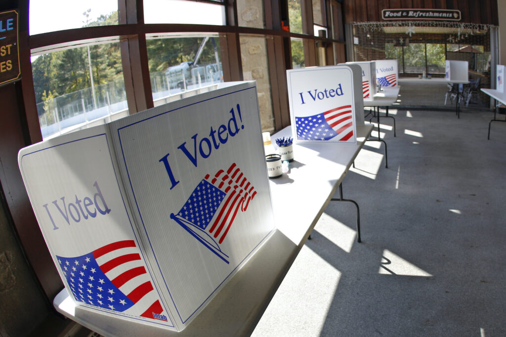 An early election ballot completion area at the North Park Ice Skating Rink Lodge area, Friday, Oct. 9, 2020, in McCandless, Pa. (AP Photo/Keith Srakocic)