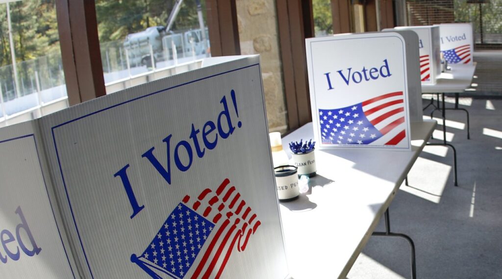AP20283786356261-e1604000953882-1920×705 An early election ballot completion area is being prepared at a collection location