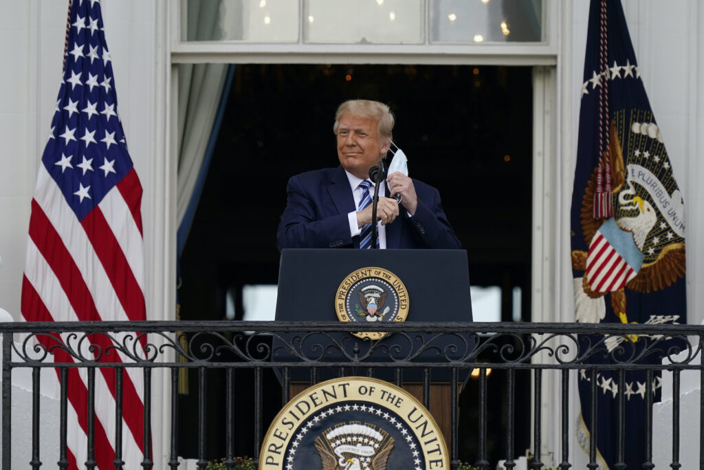 Donald Trump President Donald Trump removes his face mask to speak from the Blue Room Balcony of the White House to a crowd of supporters, Saturday, Oct. 10, 2020, in Washington. (AP Photo/Alex Brandon)