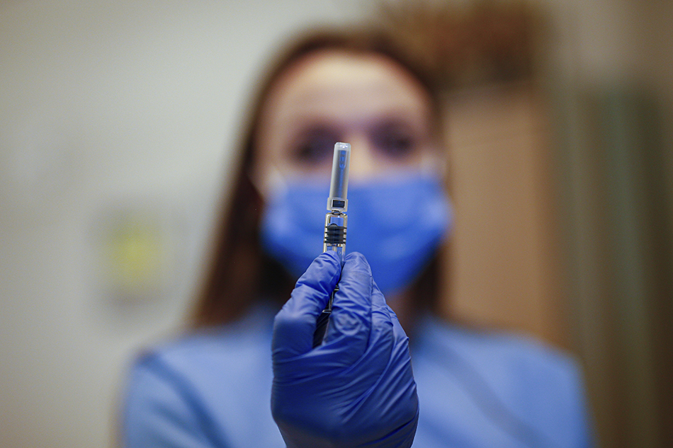 Virus Outbreak Turkey A health worker holding a COVID-19 vaccine vial