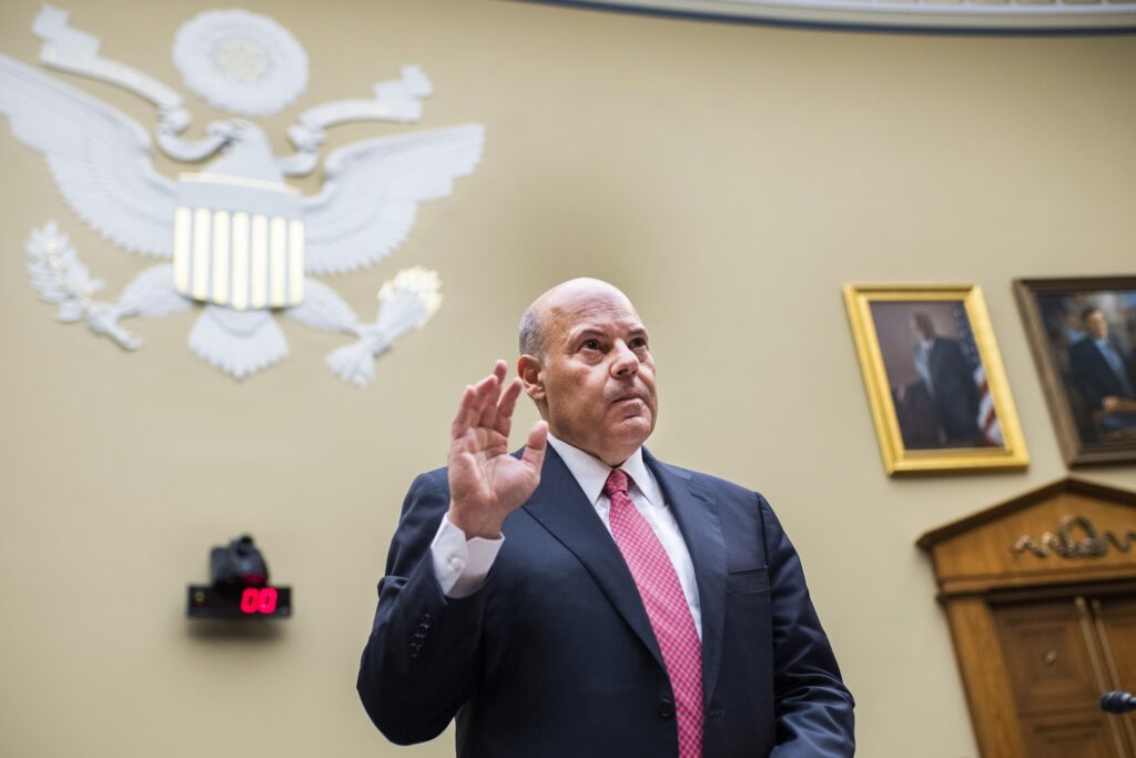 Postal Service-States-Lawsuit In this Monday, Aug. 24, 2020, file photo, Postmaster General Louis DeJoy is sworn in before testifying during a House Oversight and Reform Committee hearing on the Postal Service on Capitol Hill in Washington. (Tom Williams/Pool Photo via AP)