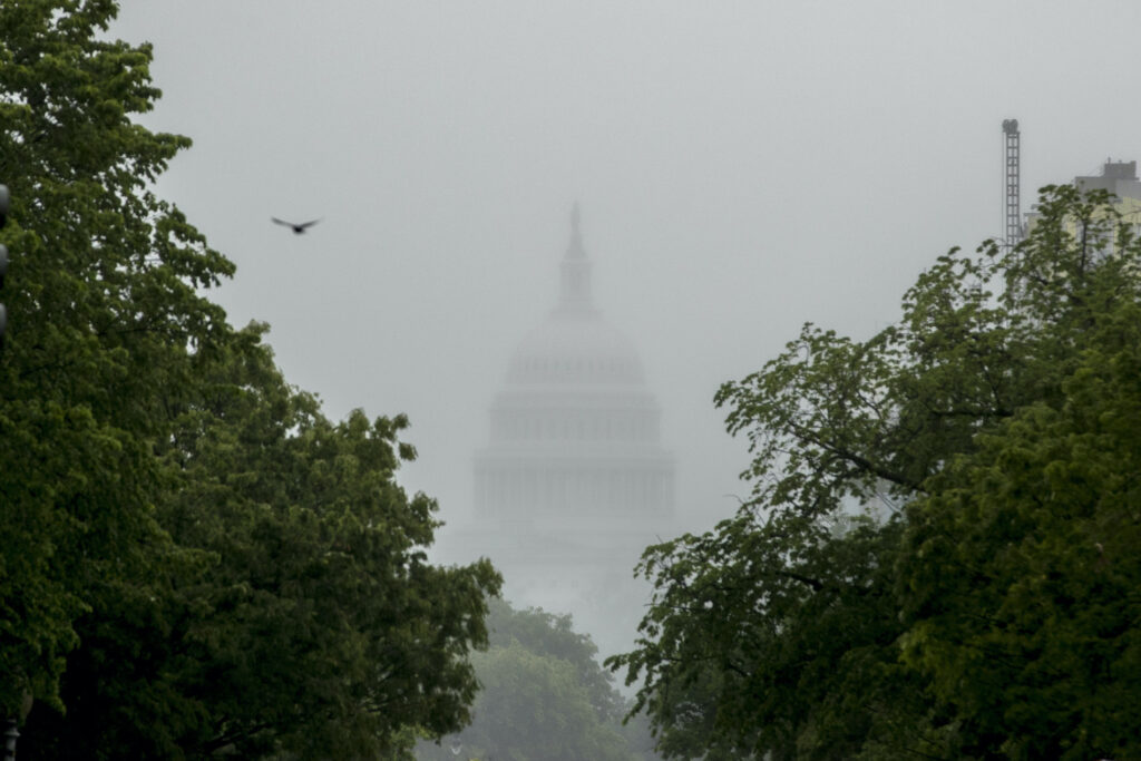 Virus Outbreak Congress In this May 22, 2020, file photo the Dome of the U.S. Capitol Building is visible through heavy fog in Washington. (AP Photo/Andrew Harnik)