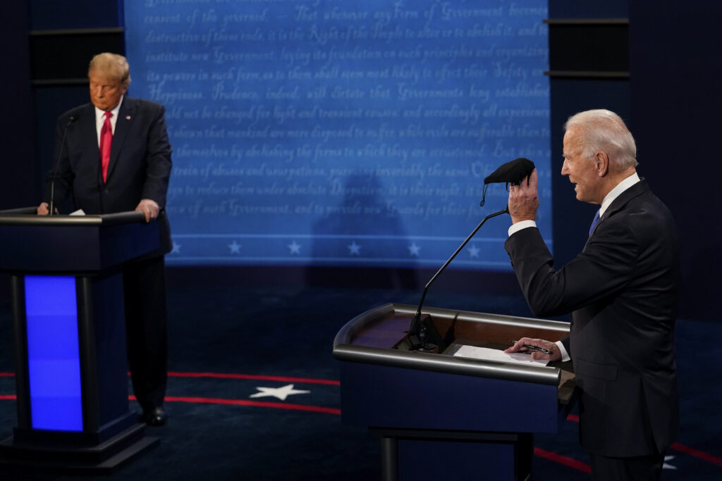 Election 2020 Debate Democratic presidential candidate former Vice President Joe Biden holds up a mask as President Donald Trump takes notes during the second and final presidential debate Thursday, Oct. 22, 2020, at Belmont University in Nashville, Tenn. (AP Photo/Morry Gash, Pool)