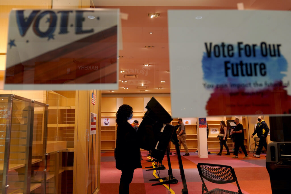 Explaining Election 2020 Counting The Vote A woman casts her ballot on the first day of early voting in a recently-shuttered store at Oak Park Mall Saturday, Oct. 17, 2020, in Overland Park, Kan. (AP Photo/Charlie Riedel)