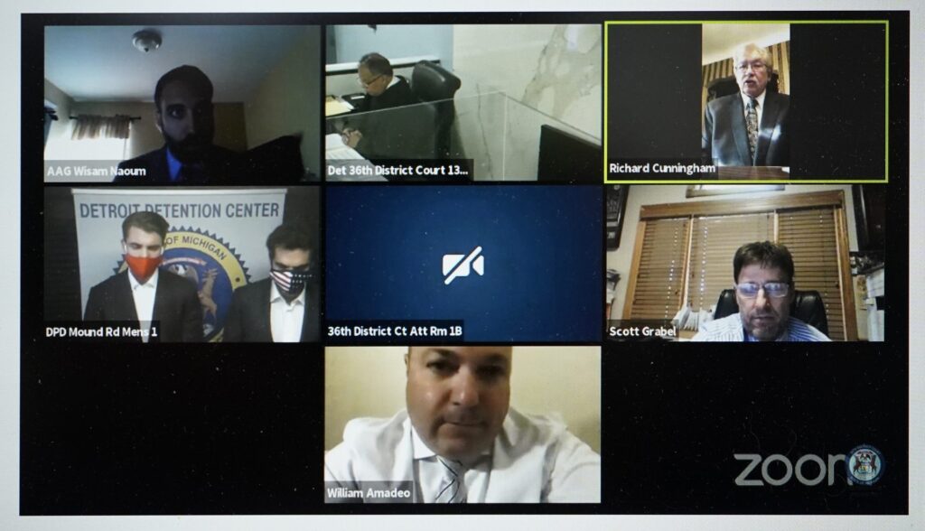 AP20304779736519-1920×1102 In this. Oct. 8, 2020 image from video provided by the 36th District Court in Detroit, Jacob Wohl, left, and Jack Burkman, shown in the center left photo, are seen during an arraignment being conducted over Zoom in Detroit. (36th District Court/Zoom via AP)