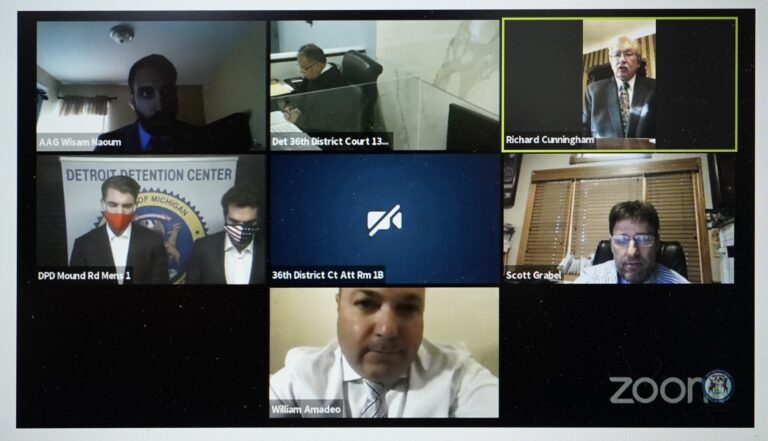 In this. Oct. 8, 2020 image from video provided by the 36th District Court in Detroit, Jacob Wohl, left, and Jack Burkman, shown in the center left photo, are seen during an arraignment being conducted over Zoom in Detroit. (36th District Court/Zoom via AP)