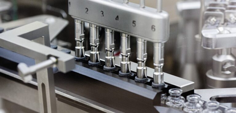 In this March 2020 photo provided by Gilead Sciences, rubber stoppers are placed onto filled vials of the investigational drug remdesivir at a Gilead manufacturing site in the United States. (Gilead Sciences via AP)