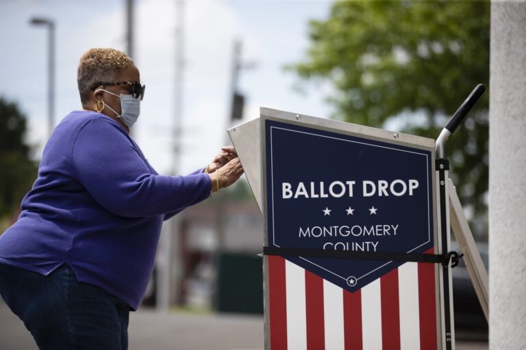 A voter drops off their mail-in ballot prior to the primary election, in Willow Grove, Pa., Wednesday, May 27, 2020. (Matt Rourke/AP Photo)