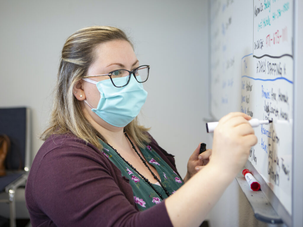 Heather Griggs, a registered nurse and operations chief of the Umatilla County Public Health Department contact tracing center in Pendleton, Ore., updates a list of job assignments on Tuesday, July 14, 2020. In tiny Umatilla County in northeastern Oregon, contact tracers work out of a converted jail to try to stem the spread of COVID-19 as new cases surge in the rural West and elsewhere. Heather Griggs, a registered nurse and operations chief of the Umatilla County Public Health Department contact tracing center in Pendleton, Ore., updates a list of job assignments on Tuesday, July 14, 2020.