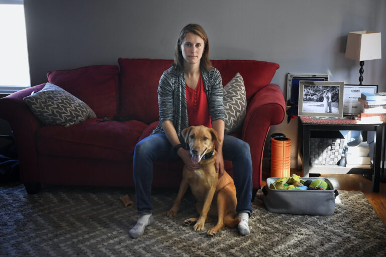 Melissa Wilhelm Szymanski sits with her dog Cooper at home in Glastonbury, Conn.