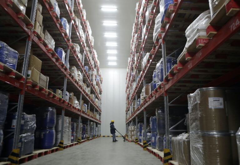 A worker moves boxes at Snowman Logistics