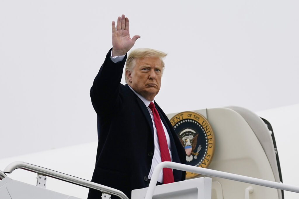 Donald Trump President Donald Trump waves as he boards Air Force One