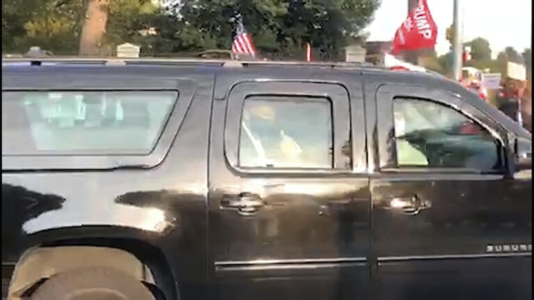 President Donald Trump drives past supporters gathered outside Walter Reed National Military Medical Center