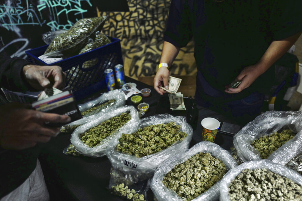 Election 2020-Marijuana Legalization A vendor makes change for a marijuana customer at a cannabis marketplace