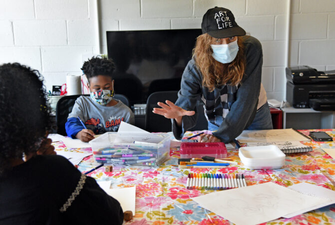 South Jersey artist Marcy Morris teaches art; at left is student Malik Lance, 9