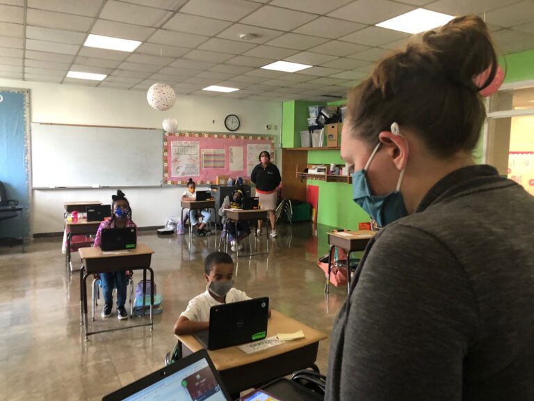 Jordan Collings teaches her EastSide Charter third-graders who are in the classroom as well as at home. (Cris Barrish/WHYY)