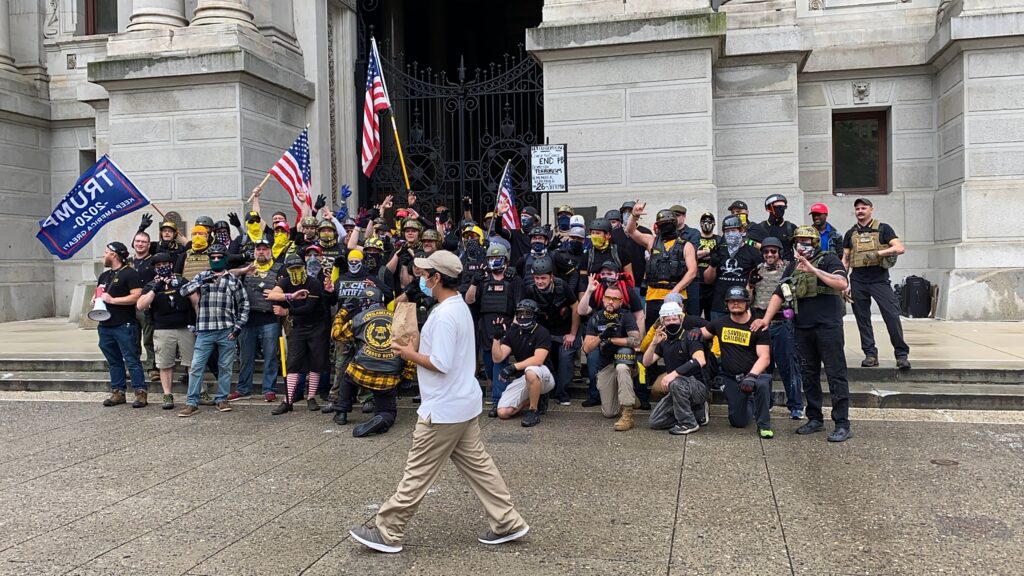 IMG_2363 Passerby walks between the camera and the Proud Boys as they pose for a photo. (Courtesy of Jason Peters)