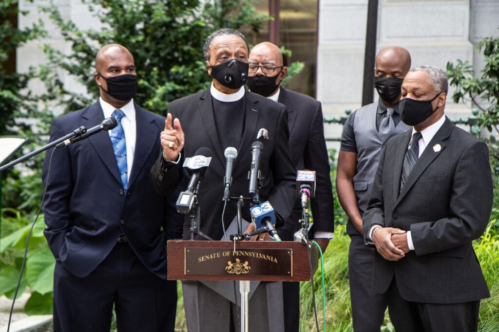 Image-from-iOS-159 Reverend Robert Collier, president of the Philadelphia Black Clergy (center), speaks at a press conferencw