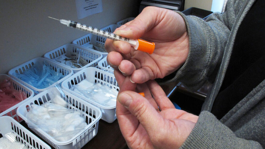 Hepatitis C Increase File photo: March 24, 2016, a nurse holds one of the syringes provided to intravenous drug users taking part in a state-approved needle exchange program in Connersville, Indiana. (AP Photo/Rick Callahan)