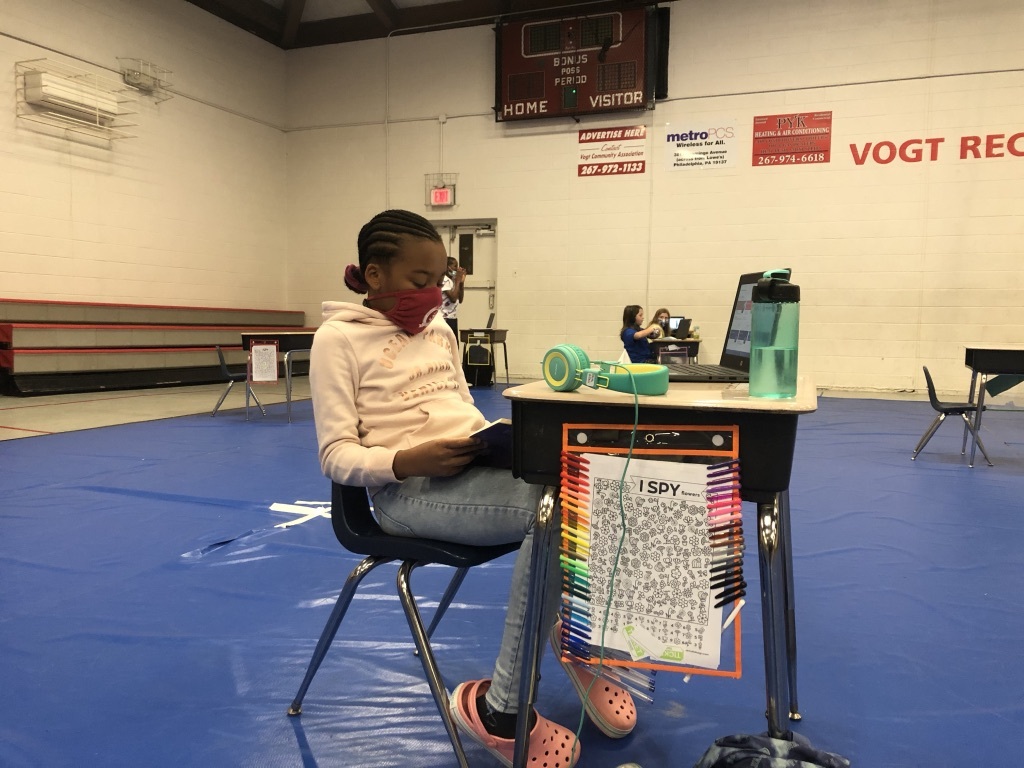 Faith Allen, 10, reads at her desk in Vogt Access Center gymnasium
