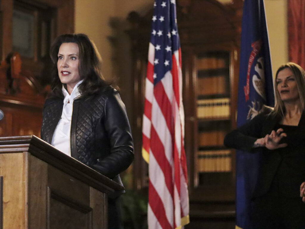 Michigan Gov. Gretchen Whitmer addresses the state during a speech Thursday in Lansing, Mich. Thirteen members of two militia groups face criminal charges after allegedly plotting to kidnap Whitmer. Michigan Gov. Gretchen Whitmer addresses the state during a speech Thursday in Lansing, Mich. Thirteen members of two militia groups face criminal charges after allegedly plotting to kidnap Whitmer.