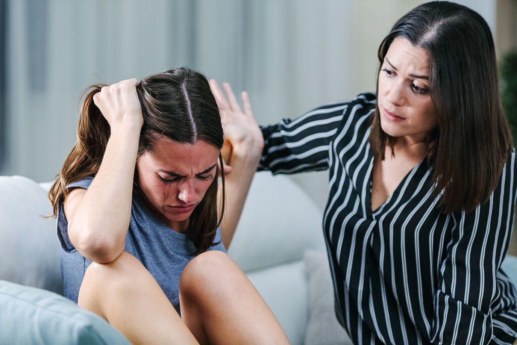 Sad Teen Rejecting Help From Her Sister On A Couch In The Living A teen upset from being rejected