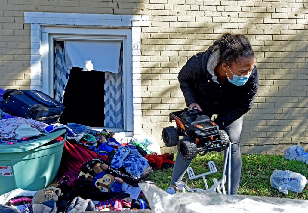 camden_apt_fire_AS_102820_07 At the Cra-West Apartments in Camden on Oct. 27, tenant Dehna Morris holds a toy that belongs to her 4-year-old son after a three-alarm fire at the complex forced them out.