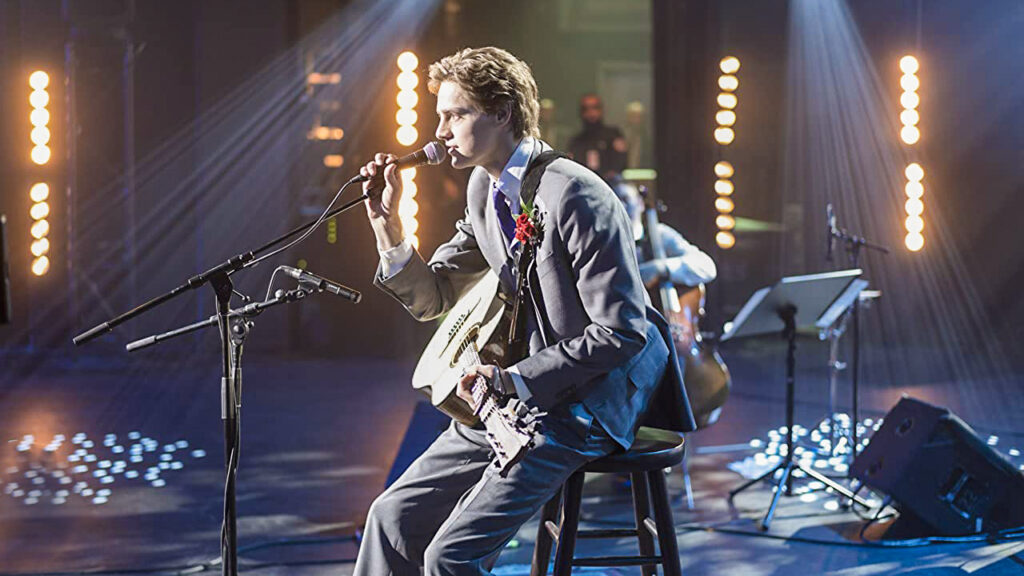 clouds_02 Actor Fin Argus on stage with a guitar singing as Zach Sobiech in the movie Clouds
