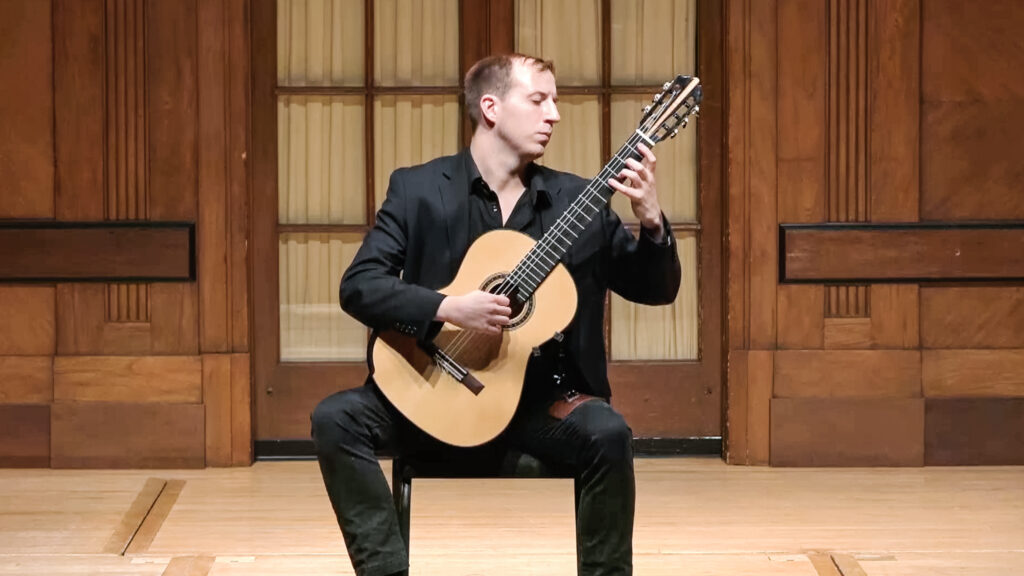 John Marcel Williams performing classical guitar on stage