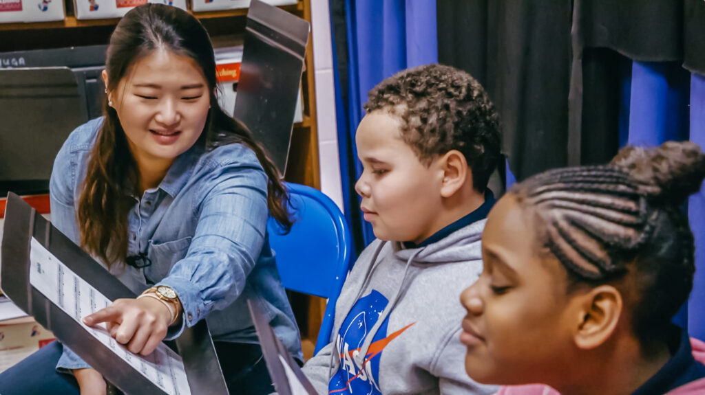 Curtis graduate Hanul Park teaching students how to read a music sheet