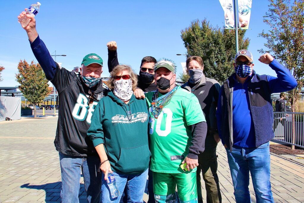 eagles_fans_linc_coronavirus_EL_101820_01 Paul and Sandy Edwards of Quakertown (foreground) and their friends (from left) John Fullerton, Jeff Morris, Tom Cooley, and Mark Lubenetski, arrive at the Linc to watch the first Eagles game of the season that is open to live fans