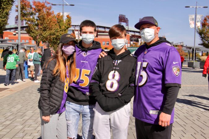 Tony Christianson (right) of Baltimore brings his family to the Eagles home game