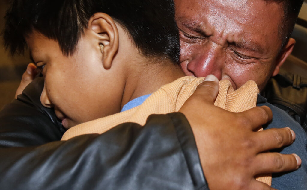 David Xol of Guatemala hugs his son Byron as they were reunited at Los Angeles International Airport in January. The father and son were separated 18 months earlier under the Trump administration’s “no tolerance” migration policy. David Xol of Guatemala hugs his son Byron