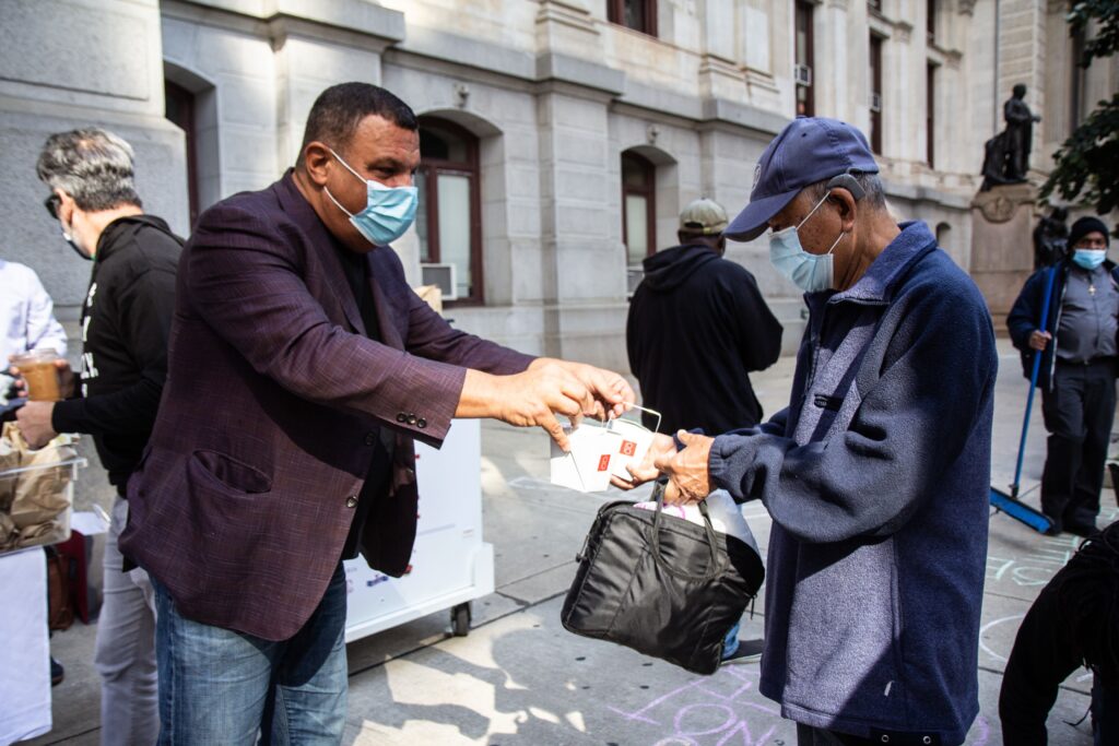 fuel_the_vote_election_KP_101520_04 Stephen Starr (left) hands out food to voters as part of the “Fuel the Vote” effort