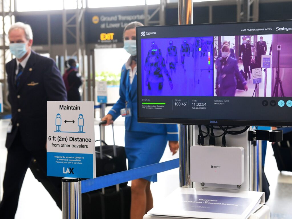 Flight crew walk past thermal cameras that check passengers’ body temperatures at Los Angeles International Airport on June 23. As businesses look to reopen, technology firms are offering an array of monitoring systems to try to control the coronavirus. Flight crew walk past thermal cameras that check passengers' body temperatures at Los Angeles International Airport on June 23. As businesses look to reopen, technology firms are offering an array of monitoring systems to try to control the coronavirus.