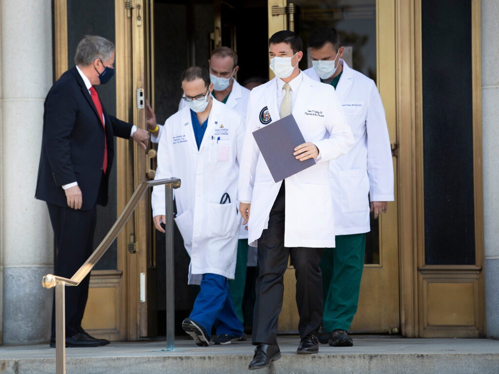 White House chief of staff Mark Meadows holds the door for Dr. Sean Conley and other members of the president’s medical team on Sunday. Another update on Trump’s condition is expected sometime on Monday. White House chief of staff Mark Meadows holds the door for Dr. Sean Conley and other members of the president's medical team on Sunday. Another update on Trump's condition is expected sometime on Monday.