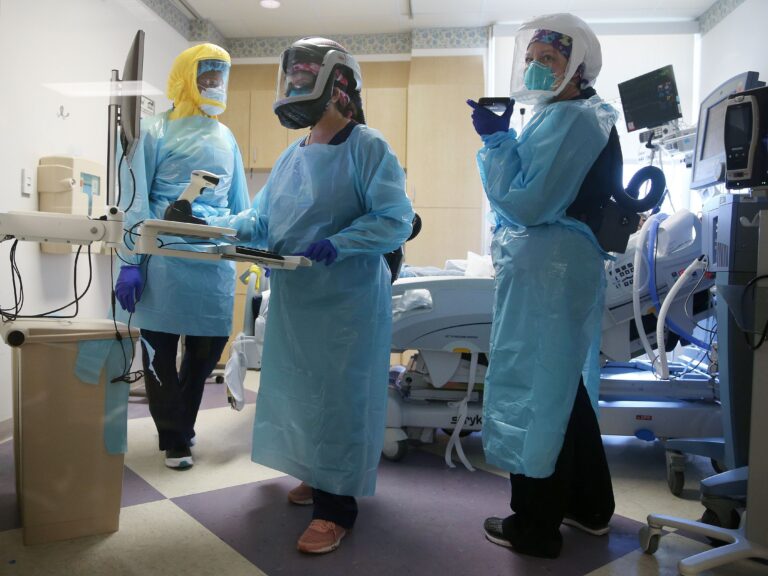 Clinicians care for a COVID-19 patient in the Intensive Care Unit
