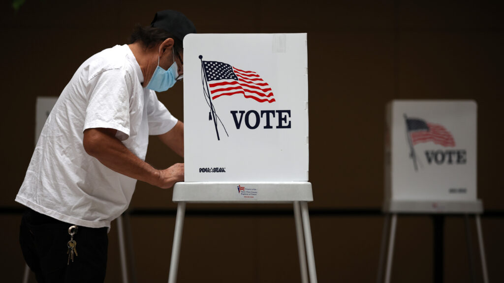 A voter fills out his ballot during early voting at the Santa Clara County Registrar of Voters office last week in San Jose, Calif. A voter fills out his ballot during early voting