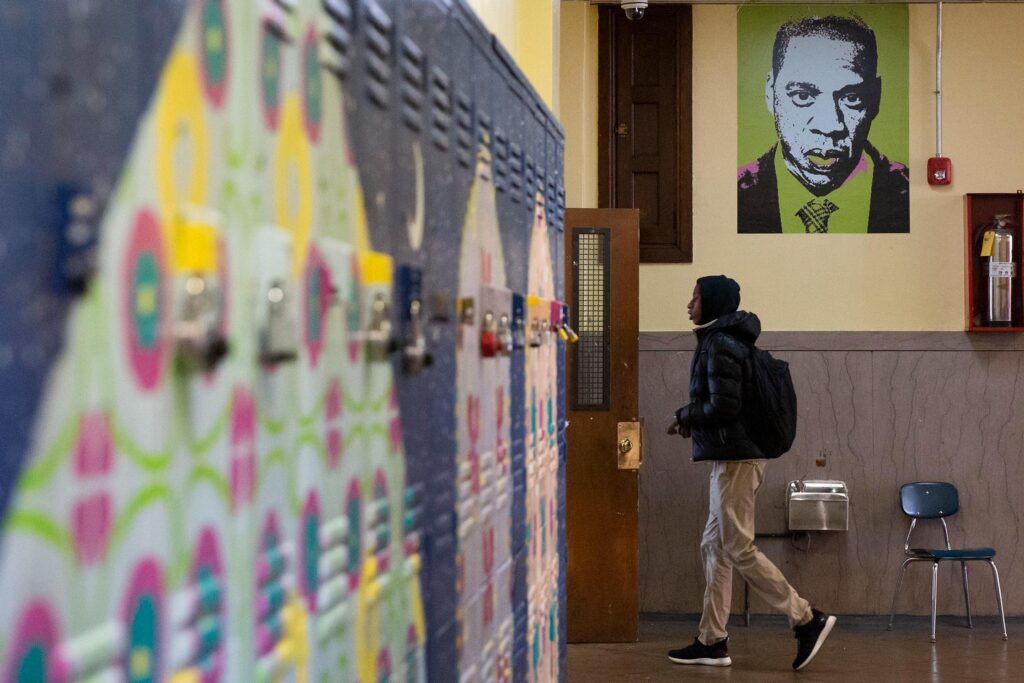 A student walks into a classroom at Jay Cooke Elementary