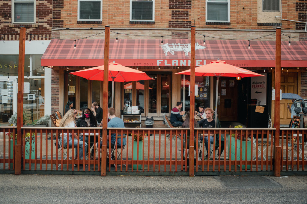 phillyparkingdining-hy10_slide-5ab9f7a904d2a4d3ff7bf463b9d6c18b95ab4cb0 Customers sit and eat in a converted parking spot outside of Flannel, a restaurant in Philadelphia.