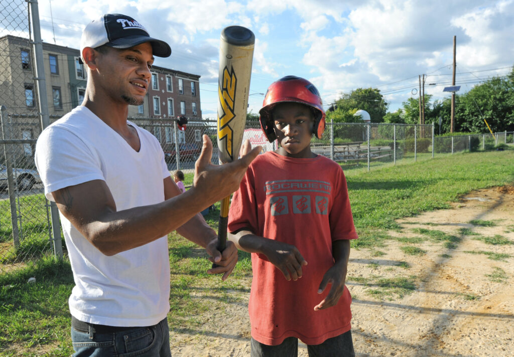 rashan4 Bryan Morton coaches a child in Camden in 2011, at about the time he founded the North Camden Little League. (April Saul for WHYY)